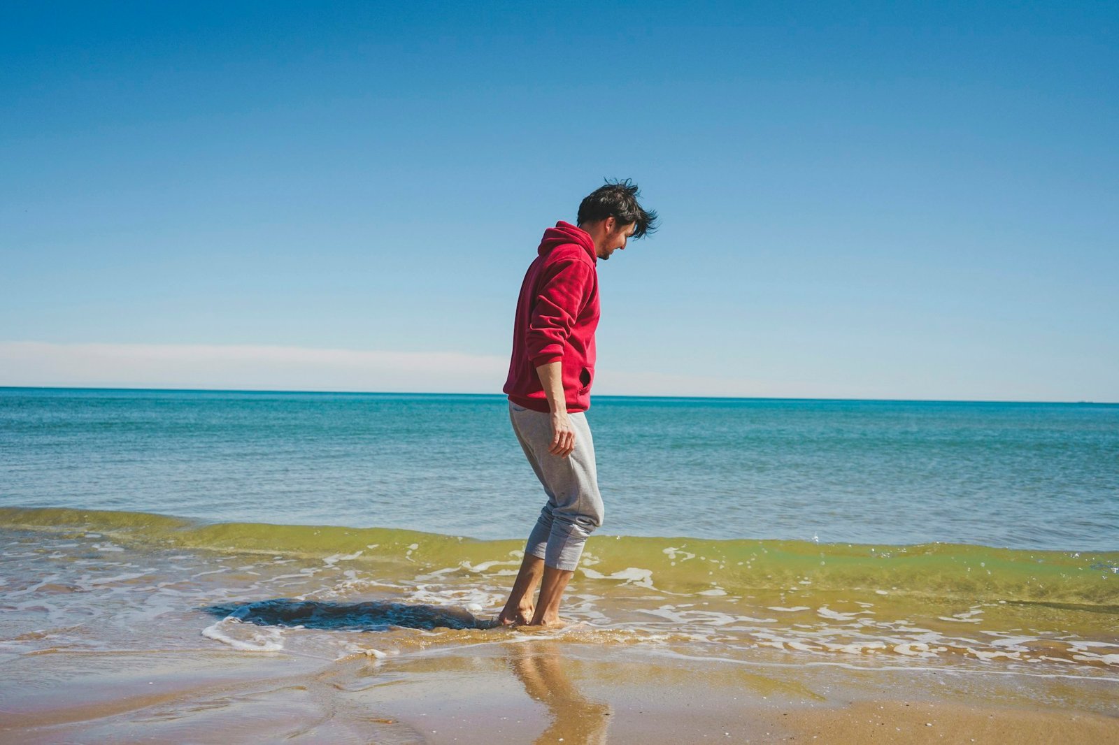 Young man walking near the sea